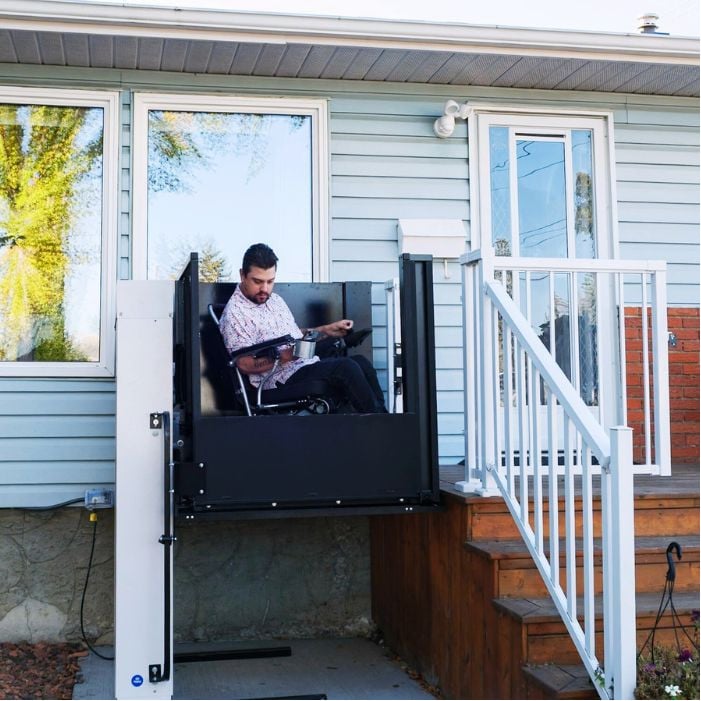 man in wheelchair at top of porch lift