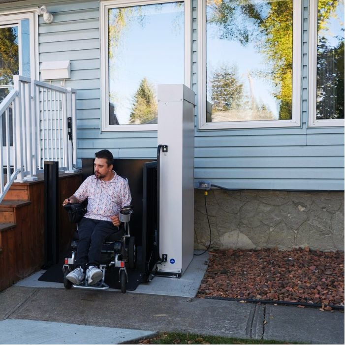 Man using wheelchair lift to enter home