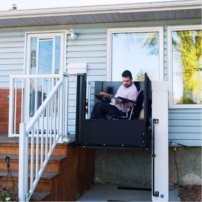 Man using wheelchair lift at top level